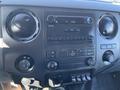 Dashboard of a 2016 Ford F-250 SD featuring a radio with buttons and knobs for volume temperature and settings