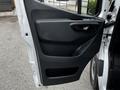A 2020 Mercedes-Benz Sprinter van door with a sleek black handle and panel design featuring window controls and textured surfaces