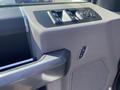 Interior view of a 2017 Ford F-150 door panel showing window controls and a door handle
