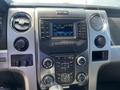 Dashboard of a 2014 Ford F-150 featuring a radio display with FM settings and various control buttons for climate and audio functions
