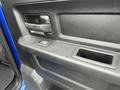 Close-up of the door panel of a 2019 RAM 1500 Classic showing the handle control buttons and a textured surface