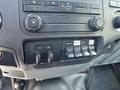 Interior dashboard controls of a 2012 Ford F-450 SD featuring climate controls and multiple toggle switches for auxiliary functions