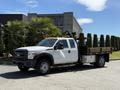 2012 Ford F-450 SD with a flatbed and utility equipment mounted on the back