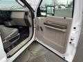 A 2010 Ford F-250 SD with an open driver's side door showing the interior features including the dashboard and seating
