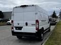 A white 2021 RAM Promaster van parked on the street with a simple rear design and no visible markings or logos on the back door