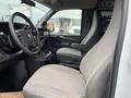 Interior view of a 2012 Chevrolet Express showing front seats and dashboard with steering wheel and control panel