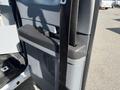 A close-up view of the driver's side door panel of a 2013 Ford F-250 SD showcasing the armrest and integrated grab handle