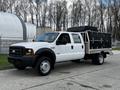 A 2007 Ford F-550 pickup truck with a black utility bed and dual rear wheels parked on a paved surface