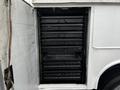 Interior of a 2009 Ford F-550 with multiple black storage drawers organized in a row inside the vehicle's compartment