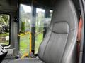 Interior view of a 2017 Chevrolet Express driver's seat with a yellow handrail and seatbelt visible