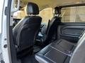 Interior view of a 2022 Mercedes-Benz Metris showcasing black leather seats in the second row and front area with a sleek design and ample space