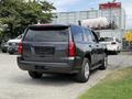 A 2017 Chevrolet Tahoe is parked with its rear visible showcasing a dark exterior and chrome accents