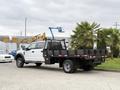 A 2020 Ford F-550 flatbed truck with a black stake bed and chrome accents parked on a lot