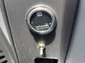 A close-up of a gauge showing hours of use on a dashboard with a key slot below it