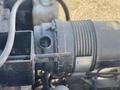 Close-up of a 2010 Kubota F3680 engine component showing a cylindrical part with a metallic surface and connecting pipes and wires