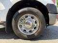 A close-up of a chrome wheel rim of a 2014 Ford F-150 with a heavy-duty tire labeled Blackhawk