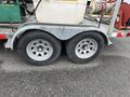 Close-up of the dual flat deck trailer's tires featuring silver rims and black tires designed for a 2011 Hightliner Aquacide Hot Water Weed Control system