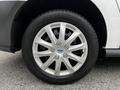 A close-up view of a silver alloy wheel with a Ford logo featuring ten spokes and a black tire with the brand name visible
