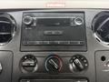 Dashboard of a 2008 Ford F-550 featuring a radio display and various climate control knobs