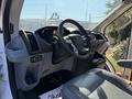 Interior of a 2017 Ford Transit showing the steering wheel dashboard and a driver's seat