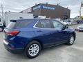 A 2022 Chevrolet Equinox parked with a blue exterior and silver trim showcasing its sleek design and modern features