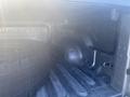 A 2021 RAM 1500 with a spare tire placed in the truck bed showing the interior structure and design of the cargo area