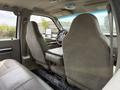 Interior view of a 2008 Ford F-550 with two front seats and a rear bench seat featuring a fold-down center console