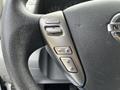 Close-up view of the steering wheel controls of a 2020 Nissan NV200 featuring buttons for source selection and audio control
