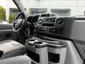 Interior of a 2021 Ford E-450 showing the dashboard and center console with controls and cup holders