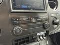 Dashboard controls of a 2015 Ford F-350 SD displaying a JVC stereo system with climate control knobs and various buttons for air conditioning and auxiliary functions