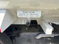 A 2015 Ford F-750 with a valve labeled caution for legal load located at the rear near the hitch assembly