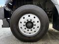 Close-up of a tire from a 2011 International WorkStar showing the wheel rim and tread pattern with visible brand name and model details on the sidewall