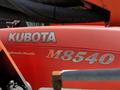 A close-up of a 2011 Kubota M8540D tractor with the brand name Kubota and model number M8540 displayed prominently
