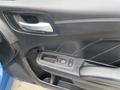 Interior door panel of a 2022 Dodge Charger featuring a sleek black design with buttons for window control and a metallic handle