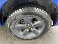 Close-up of a black alloy wheel with a prominent tread pattern designed for performance on a 2019 RAM 1500 Classic