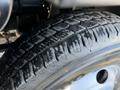 Close-up of a 2016 Isuzu NPR tire showing tread pattern with some wear and grooves designed for traction and stability