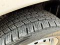 Close-up of a tire from a 2021 Nissan NV200 showing a worn tread pattern indicating signs of use