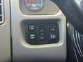 Close-up of the dashboard controls in a 2017 International 4300 featuring various buttons for mirrors lights and panel settings