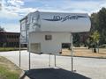 A 2018 Westland Travelaire camper mounted on legs with a sleek white design and prominent Westland logo on the side