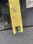 A yellow 8-foot trailer with a green valve in the foreground