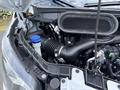 Close-up view of the engine compartment of a 2023 Ford Transit showcasing the air intake system and various engine components