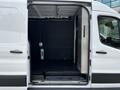 A 2022 Ford Transit with its rear doors open showing the spacious cargo area and black interior walls