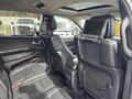 Interior view of a 2015 Dodge Durango showing black leather seats and entertainment screens mounted on the back of the front seats