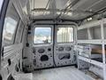 Interior view of a 2008 Ford Econoline van showing the empty cargo space with metal shelves along the sides and windows on the back doors