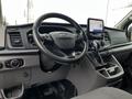 Interior of a 2021 Ford Transit showing the steering wheel center console and touchscreen display