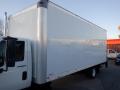 A 2014 International Durastar box truck with a large white cargo area and a truck cab visible on the left side