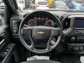 The interior dashboard of a 2021 Chevrolet Silverado 3500HD featuring a steering wheel with controls and a display panel with gauges and infotainment system