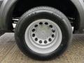 A close-up view of a silver wheel with a multi-spoke design on a 2021 Ford Transit