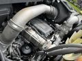 A close-up view of the engine compartment of a 2017 International WorkStar 7600 showing various engine components including pipes and hoses
