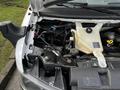 Engine compartment of a 2017 Chevrolet Express showing various components including the coolant reservoir and wires